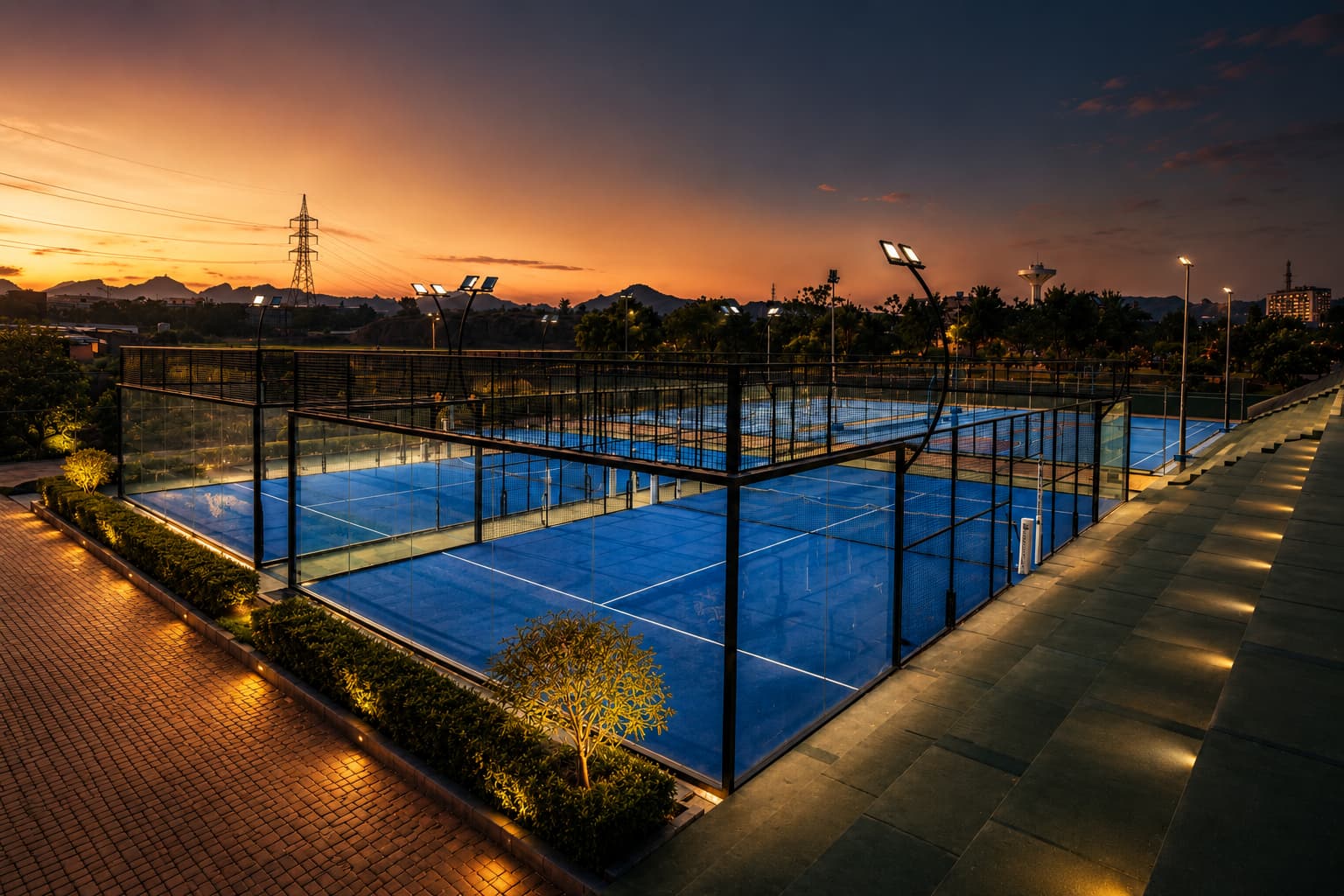 Floodlit padel courts at Grand Unicorn Club